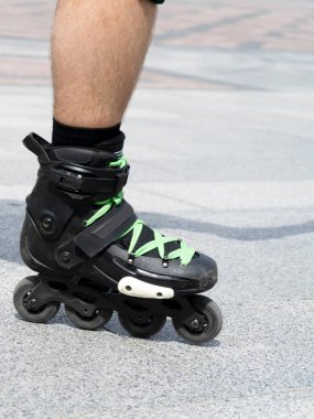 Patenli erkek bacaklarının yakın çekim görüntüsü. Paten üzerinde artistik patinaj..