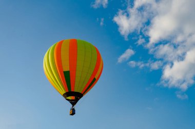 Mavi gökyüzünde uçan renkli sıcak hava balonları. Çok az renkli, sıcak hava balonu Balon Festivali 'ne iniyor..