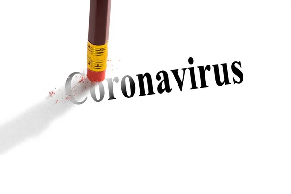 ペンシル消しゴムは、紙の上の単語「コロナウイルス」を削除しようとします。ウイルスとの闘いの概念 — ストック写真