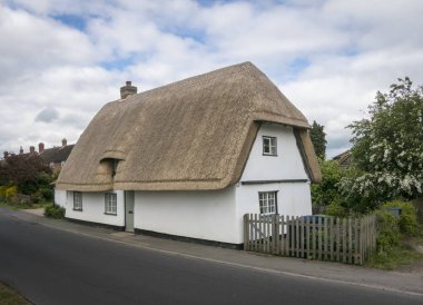 Thatched Cottage in an English Village clipart