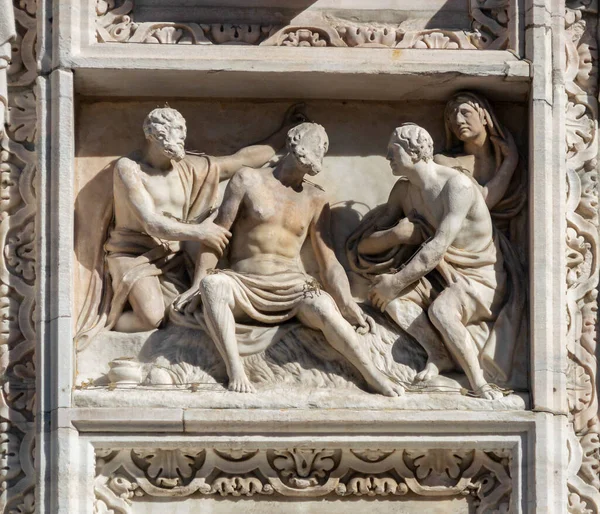 Relief detail on the facade of the cathedral in the city of Milan, Italy