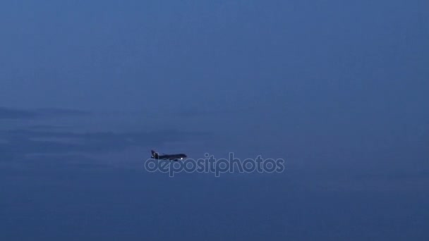 Flugzeug fliegt über blauen Abendhimmel — Stockvideo