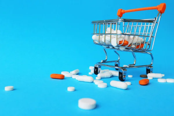 Tablets Shopping Cart Blue Background Concept Buying Drugs Prices Treatment — Stock Photo, Image