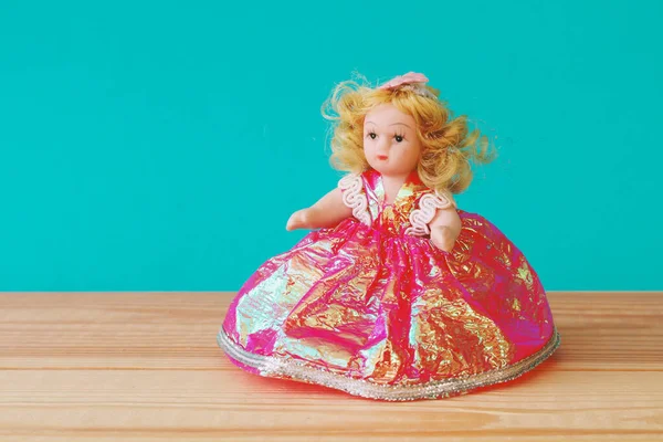 cute doll toy on wooden table