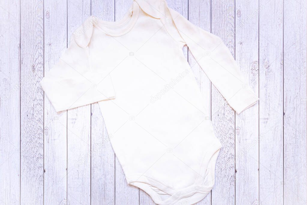 Newborn White Blank Unisex Baby Styled Bodysuit with teddy bear toy. Flat Lay Mockup.