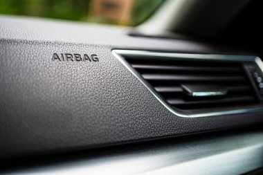 3-D Engraved Airbag Symbol Lettering Bottom Frame Left in Grainy Textured Black Dashboard with Air conditioning system. Interior details. clipart