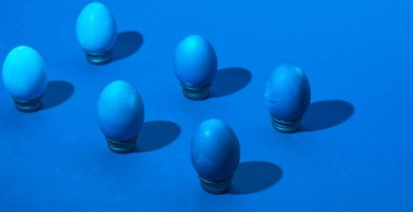 Yumurta tutucuların üzerinde paskalya yumurtalarının izometrik yerleşimi. Klasik mavi monokromatik kompozisyon. sert gölgeler