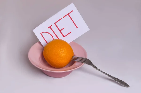 Transição para nutrição adequada Dieta de palavras em um fundo branco com uma laranja em uma placa — Fotografia de Stock