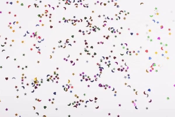 Fond blanc avec beaucoup de paillettes de différentes formes — Photo