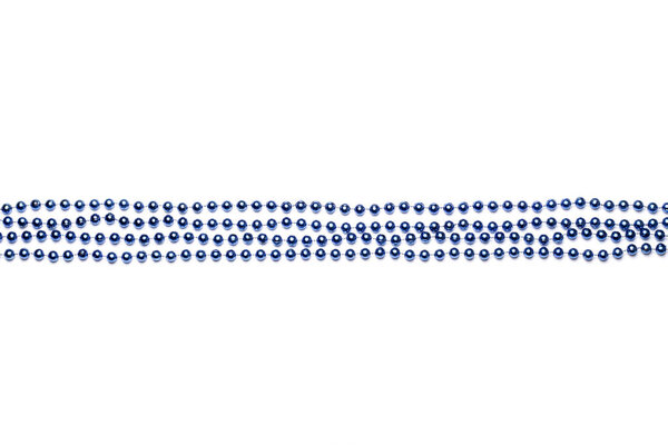 Beads laid out in straight rows on Mardi Gras blue on white background Royalty Free Stock Photos
