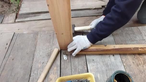 Man Connects Parts Knocks Nail Hammer Wooden Block — Stock Video