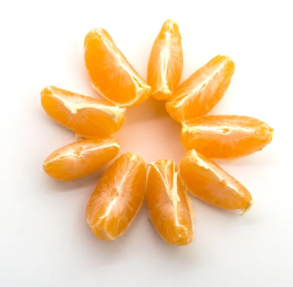 One peeled orange tangerine on a white background with divided slices laid out in the form of a flower — Stock Photo, Image