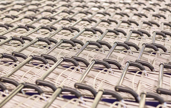 Row of empty shopping trolleys carts supermarket shop close up