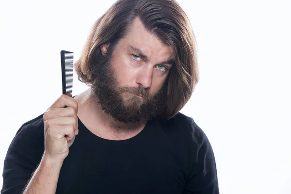 Man combs his hair with comb brush isolated on white — Stock Photo, Image