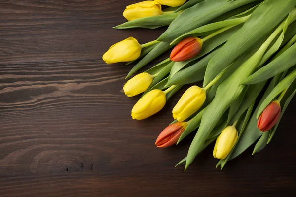 Colorful tulips on wooden table — Stock Photo, Image