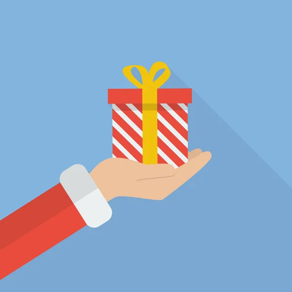 Santa mano celebración de la caja de regalo de Navidad — Vector de stock