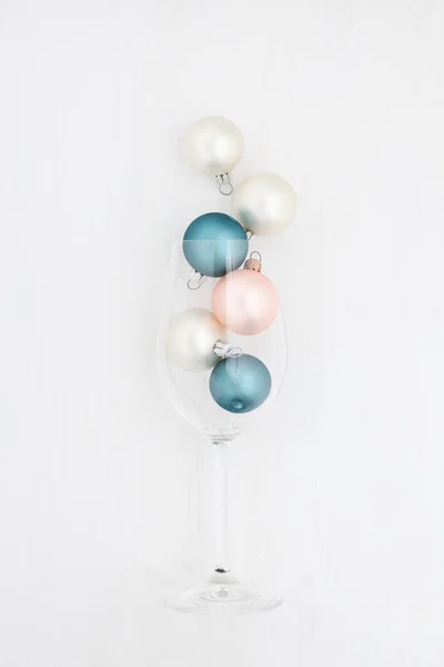 Christmas balls in a champagne glass on a white background — Stock Photo, Image