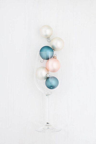 Christmas balls in a champagne glass on a white background