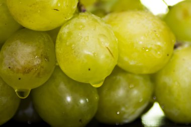 Siyah bir kayrak taş üzerinde üzüm demet