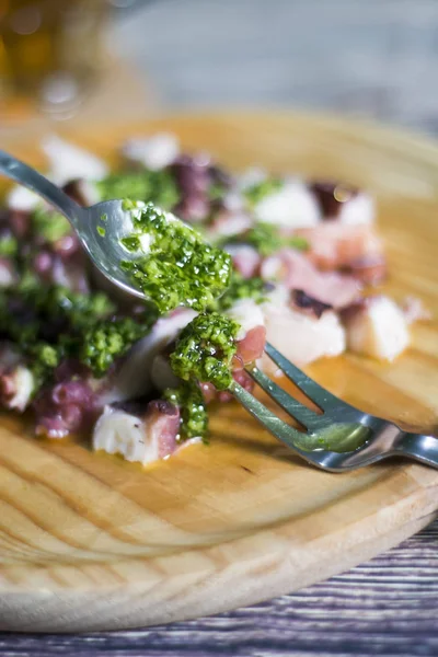 Octopus with paprika and beer, typical dish of Spain, on a woode — Stock Photo, Image