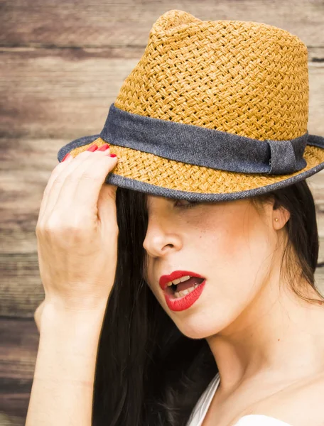 Beauty Woman with hat  on a wooden background
