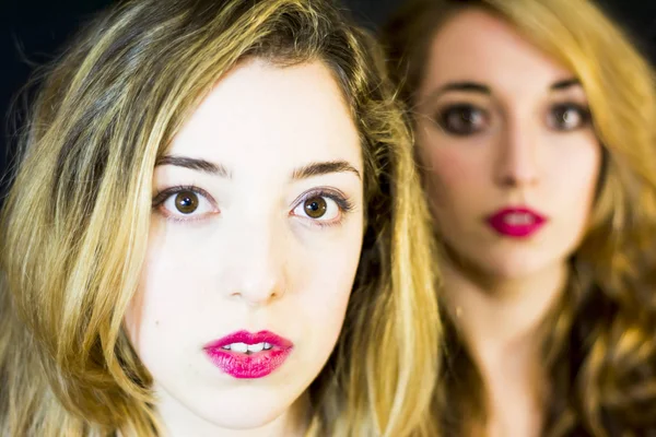 Two beautiful women Portrait over Black Background — Stock Photo, Image