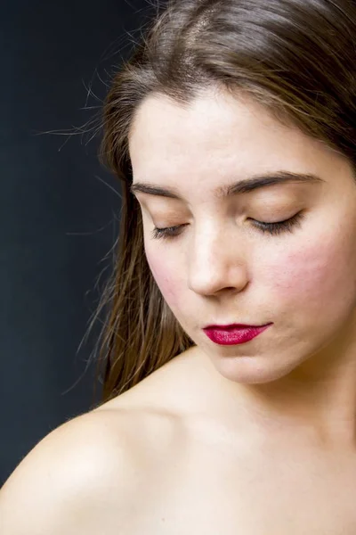 Portrait of a beautiful woman on black background — Stock Photo, Image