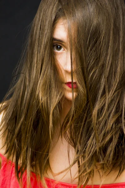 Retrato de una hermosa mujer con el pelo caído en la cara — Foto de Stock