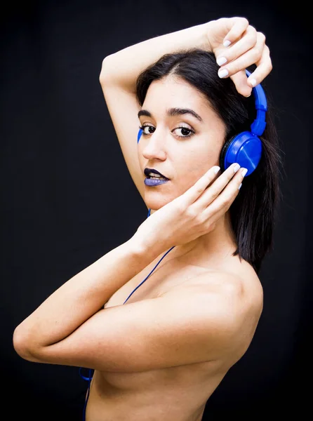 Beautiful woman with headphones on black background — Stock Photo, Image