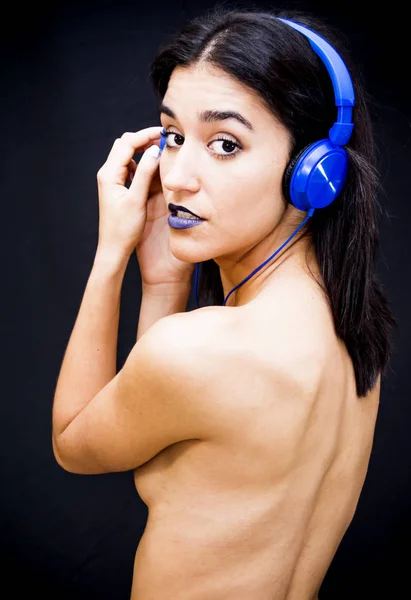 Beautiful woman with headphones on black background — Stock Photo, Image