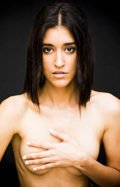Beautiful naked woman covering her breasts — Stock Photo, Image