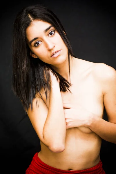 Beautiful naked woman covering her breasts — Stock Photo, Image