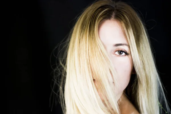 Portrait of a beautiful woman on black background — Stock Photo, Image