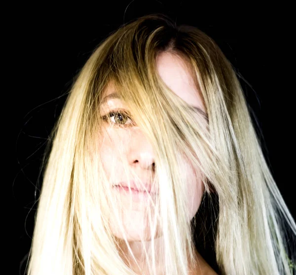 Portrait of a beautiful woman on black background — Stock Photo, Image