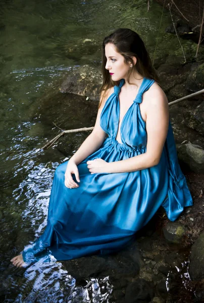 Mooie vrouw aan de oever van een rivier berg met een avond — Stockfoto