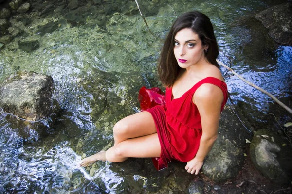 Hermosa mujer en la orilla de un río de montaña con una noche — Foto de Stock