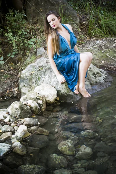 Belle femme au bord d'une rivière de montagne avec une soirée — Photo