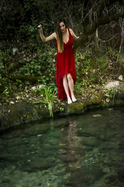 Hermosa mujer en la orilla de un río de montaña con una noche — Foto de Stock