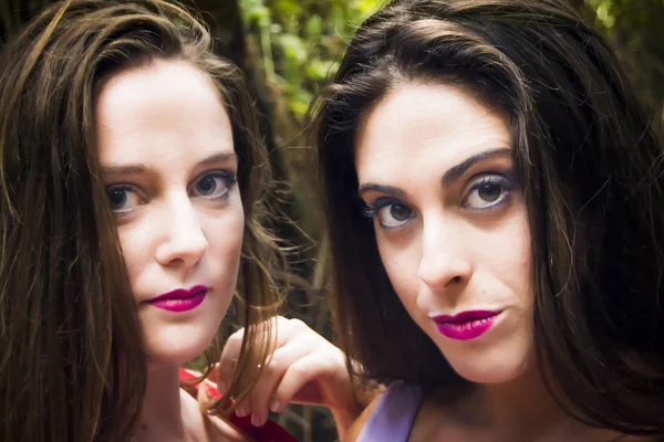 Portrait of the face of two beautiful women in the forest — Stock Photo, Image