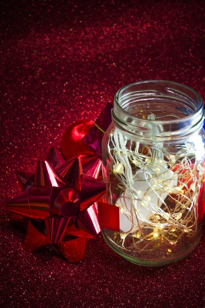 Christmas ornaments on red background with lights like stars Stock Picture