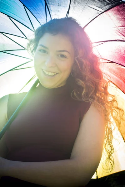 Beautiful woman with umbrella in backlight on a sunny day