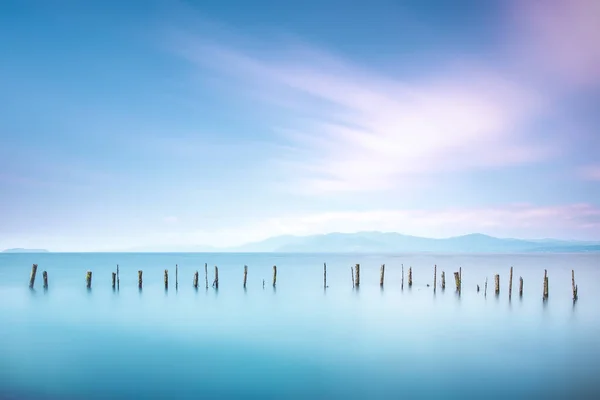 Poles and soft water on sea landscape. Long exposure. — Stock Photo, Image