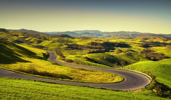 Toskánsko – krajina, silniční a zelené pole. Volterra, Itálie — Stock fotografie