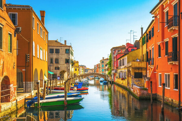 Chioggia town in venetian lagoon, water canal and church. Veneto