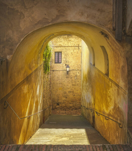 Colle Val d'Elsa, picturesque street and gallery in old town. Siena, Tuscany, Italy.