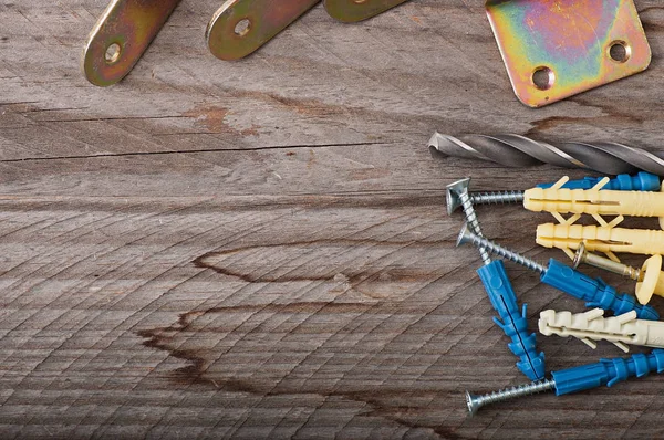 Metal work tools on the old wooden background