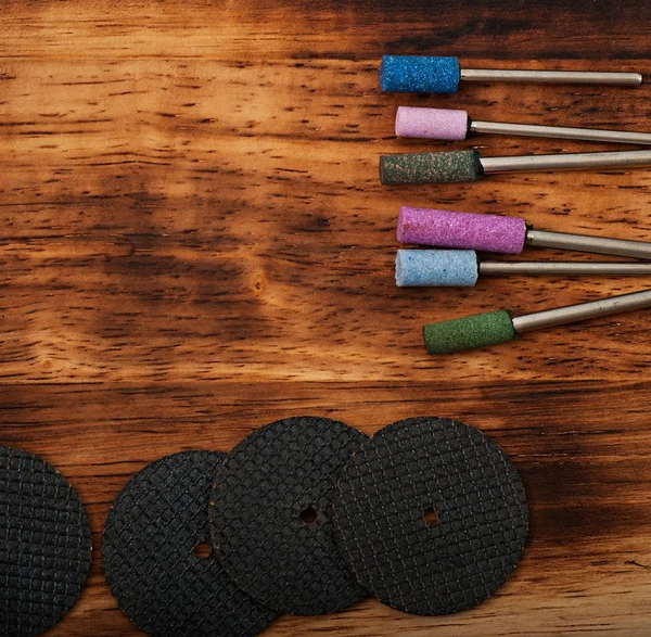 Metal work tools on the old wooden background