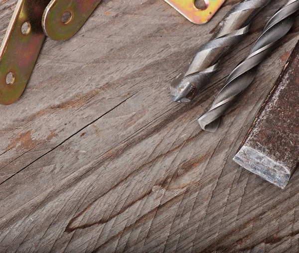 Metal work tools on the old wooden background