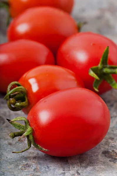 Cherry tomatoes on an old metal background. — Stock Photo, Image