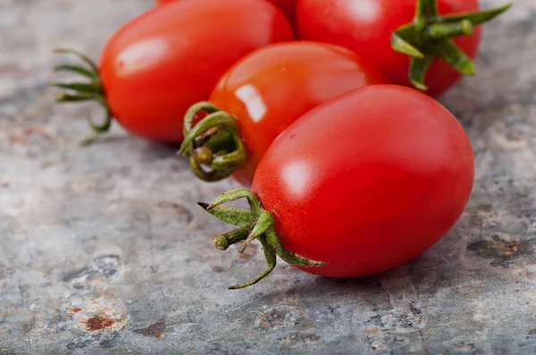 Cherry tomatoes on an old metal background. — Stock Photo, Image